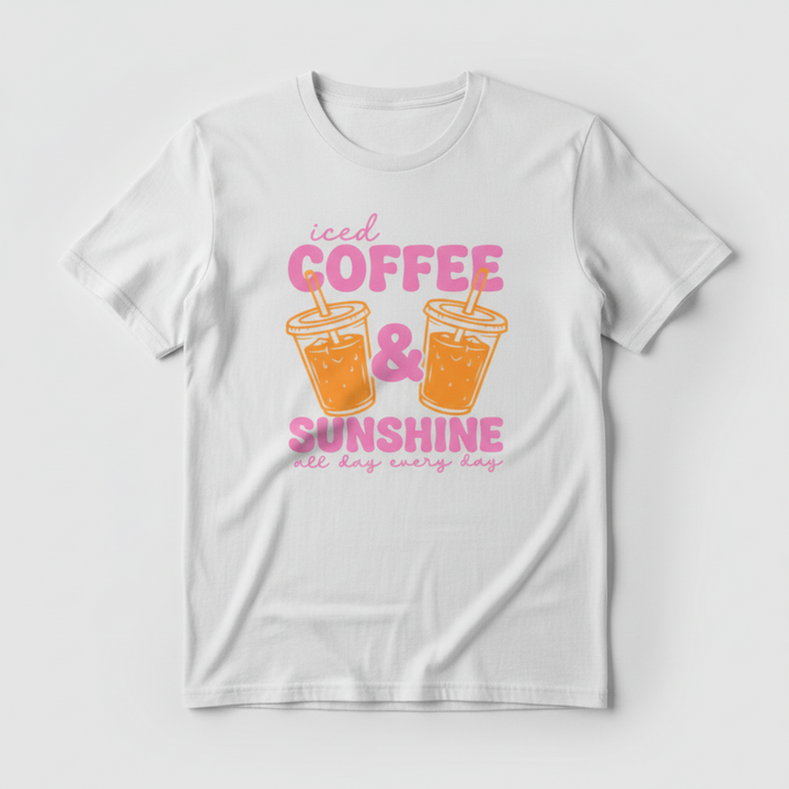 Adorable Coffee Lover Tee featuring bold retro-style pink lettering with two illustrated iced coffee cups, available in hot pink, orange, and white.