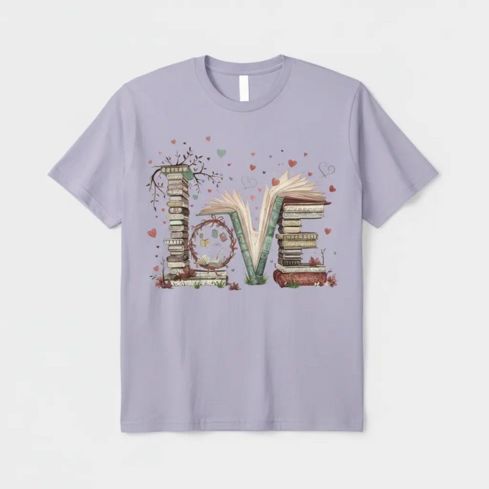 Charming Cute Bookworm Graphic Tee showcasing a detailed illustration of a cozy stack of literary books forming the word LOVE with floating hearts and delicate branches.