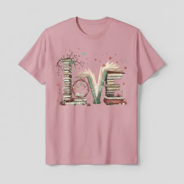 Charming Cute Bookworm Graphic Tee showcasing a detailed illustration of a cozy stack of literary books forming the word LOVE with floating hearts and delicate branches.